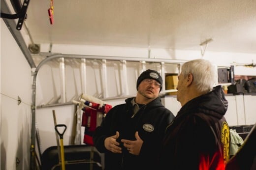 Precision Technician Discussing Garage Door Issue with Customer