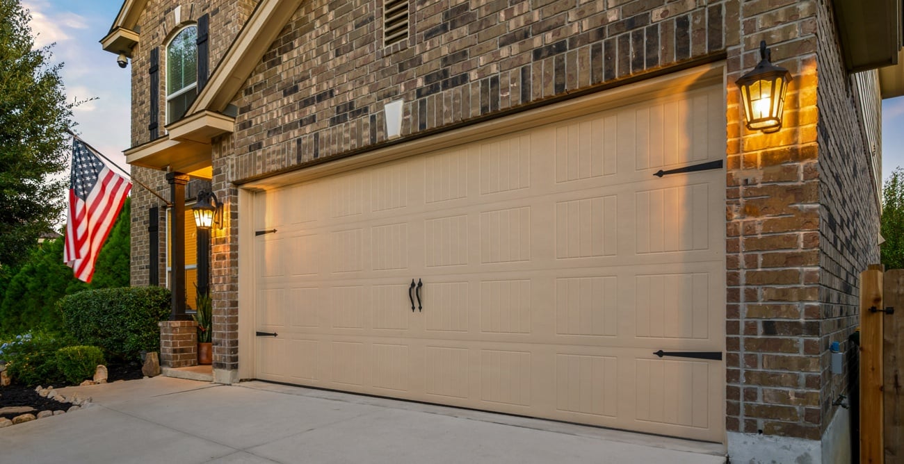 Exterior garage door in summer sunset with American flag hanging outside Exterior garage door in summer sunset with American flag hanging outside