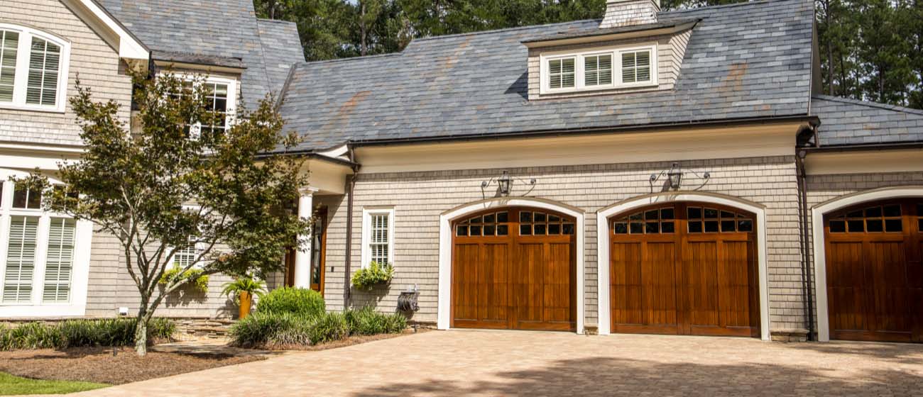 Home with Triple Wooden Garage Doors