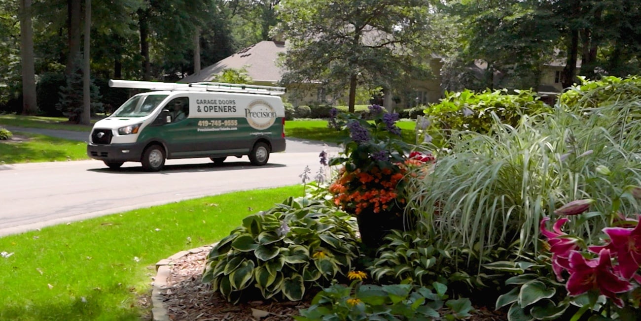 Precision Garage Door Service of Toledo technician truck driving in subdivision Precision Garage Door Service of Toledo technician truck driving in subdivision