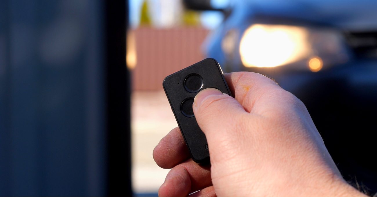 Man pressing garage door opener remote Man pressing garage door opener remote