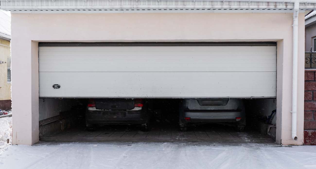 Snowy Driveway and Garage Door Closing