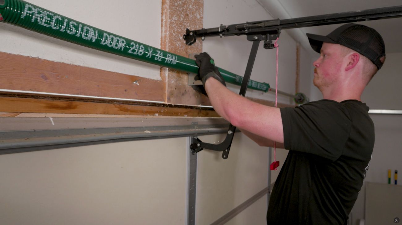 Precision Garage Door Service of Toledo technician installing new garage door spring Precision Garage Door Service of Toledo technician installing new garage door spring