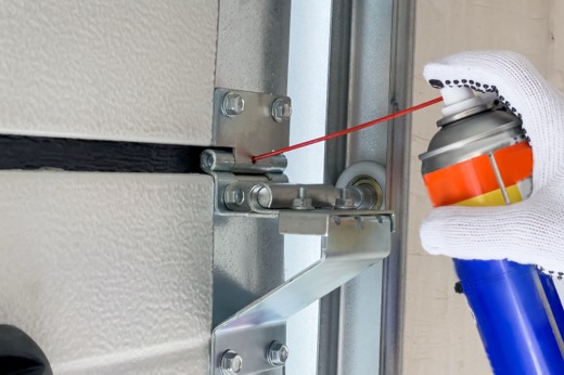 Spraying garage door hinge