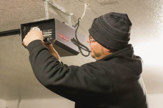 Technician Repairing a Garage Door Opener