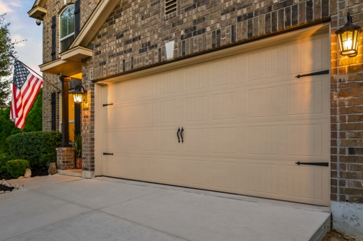 Garage door exterior in summer with American flag hanging outside