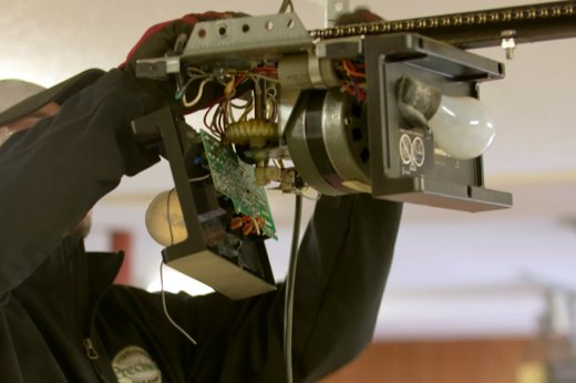 Precision Technician Installing a New Garage Door Opener